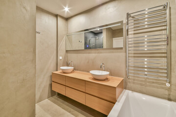 Bathroom with sink on cabinet and mirror heated towel rails