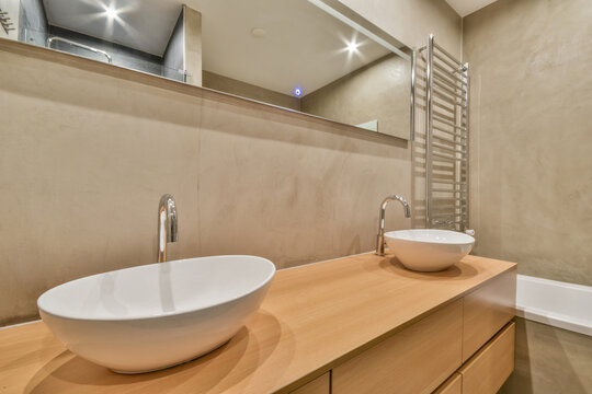 Bathroom with sink on cabinet and mirror heated towel rails