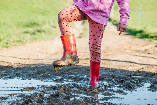 Anonymous kid standing on dirty ground