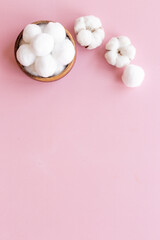 Fototapeta na wymiar Cotton baby balls with cotton flowers, top view