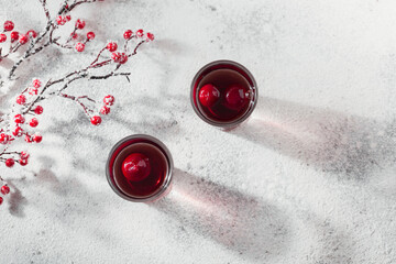 Two glasses of cherry liqueur on white background - obrazy, fototapety, plakaty