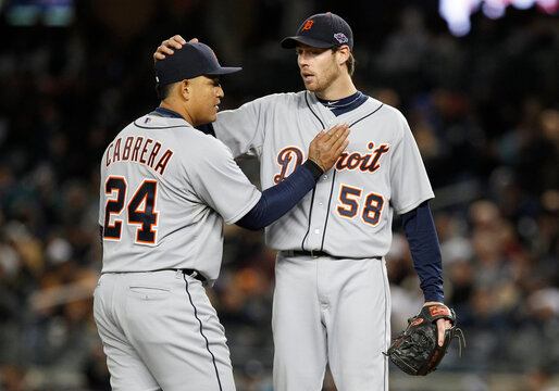 Detroit Tigers starting pitcher Fister is congratulated by his teammate Cabrera before being pulled from the game during the seventh inning of Game 1 of their MLB ALCS playoff baseball series in New York