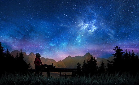 Girl watching the stars and nebula in night sky