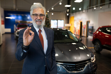 Portrait of happy car salesman with big experience