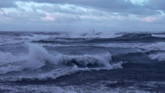 Stormy weather by the sea in Riga, Latvia. Huge waves crashing down the coast of Latvia during the storm.