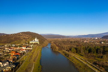 The Mukachevo city at the evening with beautiful mountains aerial view