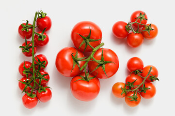 Various tomatoes on white background.