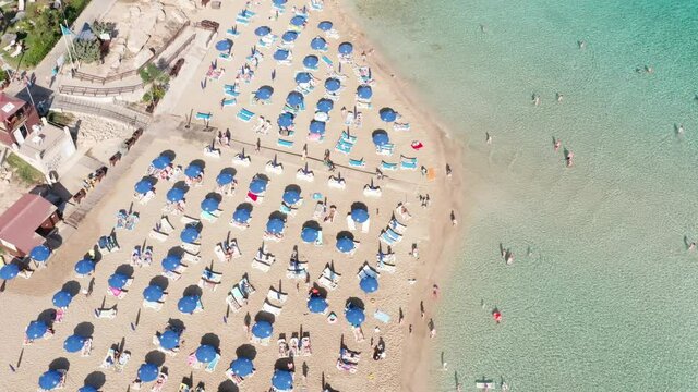 Aerial view fig tree bay beach in Protaras resort Cyprus, summer season. Tourist sunbathe on the sunbeds