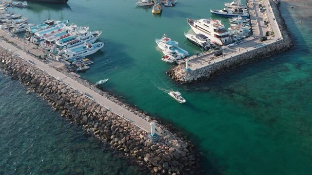 Small tourist yacht running from marine in Aya Napa, aerial view. Summer sunny day