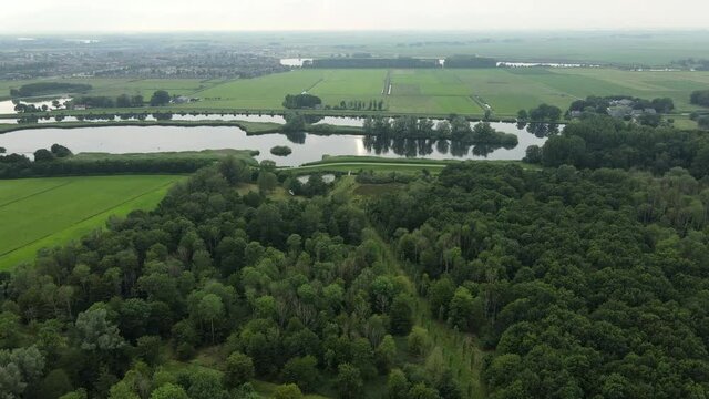 Aerial top view of a city in Holland, surrounded by houses, green trees and canal