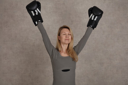 Woman with boxing gloves enjoying the Victory feeling. Struggle and Success concept