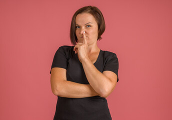 bad smell concept, woman covering her nose with her finger from strong stench on pink background