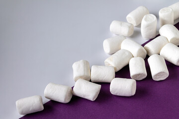 Fototapeta na wymiar white marshmallow on a very peri background, selective focus