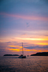 Sailing boat during sunset at Promthep Cape in Phuket peninsula, Thailand