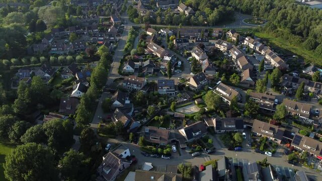 Aerial top view of a city in Holland, surrounded by houses, green trees and canal