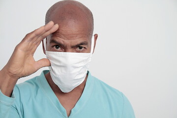 man with face masks fighting the coronavirus on grey background stock photo 