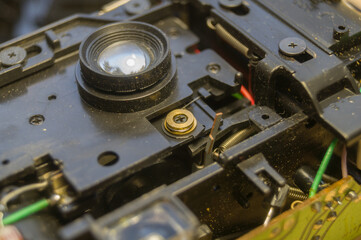 Disassembled compact camera. Internal parts of the broken camera being repaired in the workshop....
