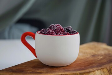 cup of berries in the wooden desk
