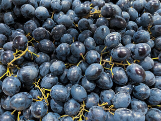 Background of fresh dark grapes in the store 