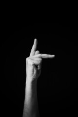 B+W image of hand demonstrating Chinese sign language letter K isolated against black background