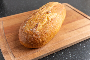 fresh white bread on brown wood cutting board