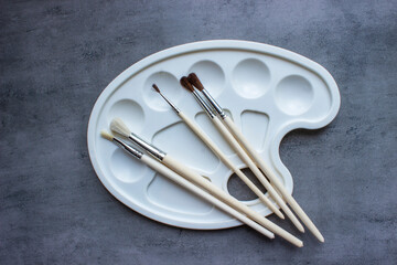 Blank paper and tassels, tea on the wooden table. View from above