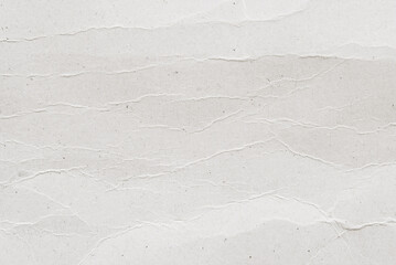 Obraz premium A sheet of white recycled wrinkled cardboard, white clean poster paper texture