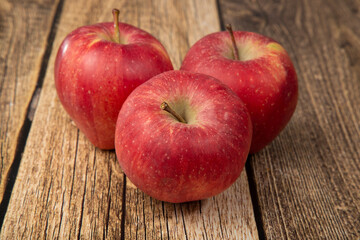 Red apples on a wooden background.The fruit is fresh.