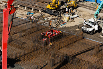 workers make metal reinforcement for the foundation