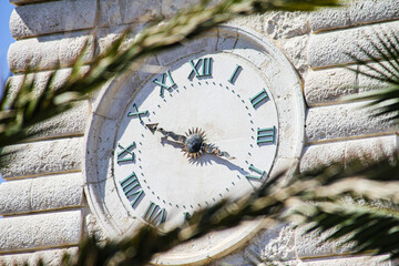 detail of ancient stone clock on granite tower. Trani, Puglia, Italy
