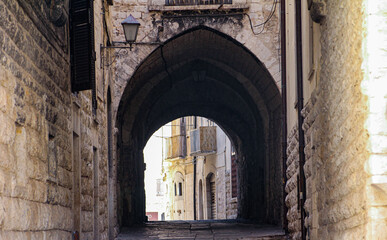 view of alley with arch in the old town of Trani, Puglia, Italy