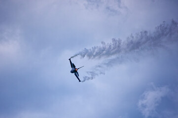 Fototapeta na wymiar Jet on airshow in clouds