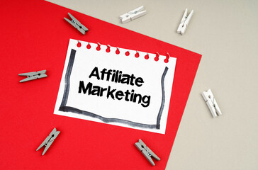 Clothespins and a sheet of notebook with the inscription - Affiliate Marketing