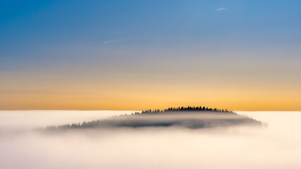 The floating hill above cotton clouds painted by sunrise