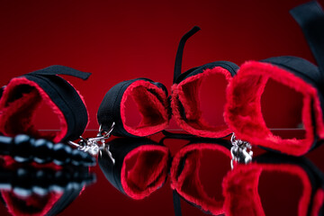 erotic bdsm toys for intimate sex games red soft handcuffs next to adult toys