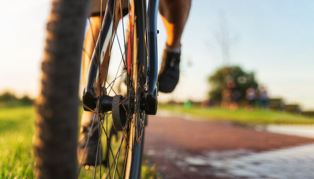 Cyclist on a bike. Front bicycle wheel close up. Sports and active lifestyle concept.
