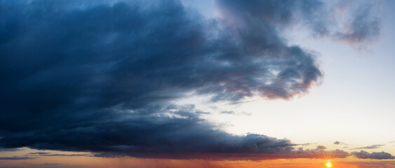 Sunset sky with dark clouds. Landscape background.