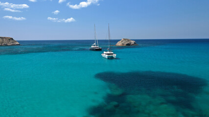 Obraz premium Aerial drone photo of small paradise tropical island and sandy beach forming an emerald clear sea lagoon