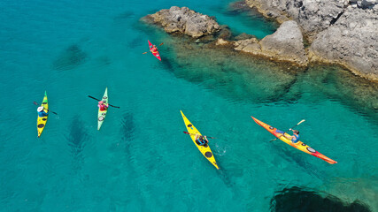 Aerial drone photo of women athletes rowing in sports kayak in tropical Caribbean exotic destination with turquoise calm sea