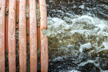 A stream of water flows from a large flexible pipe - hose.