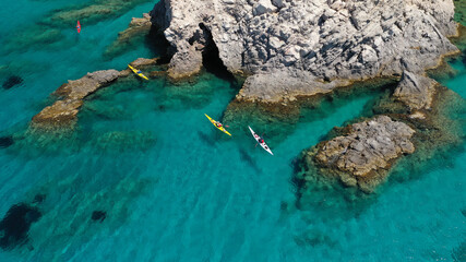 Aerial drone photo of women athletes rowing in sports kayak in tropical Caribbean exotic destination with turquoise calm sea