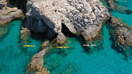 Aerial drone photo of women athletes rowing in sports kayak in tropical Caribbean exotic...