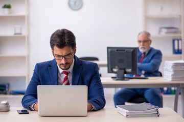 Two male colleagues working in the office