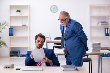 Fototapeta premium Two male colleagues working in the office