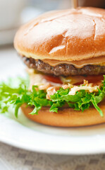 Rustic hamburger with melted cheese and beef cutlet.
