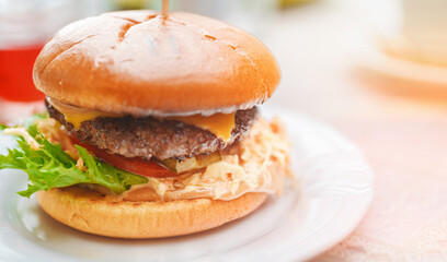 Rustic hamburger with melted cheese and beef cutlet.