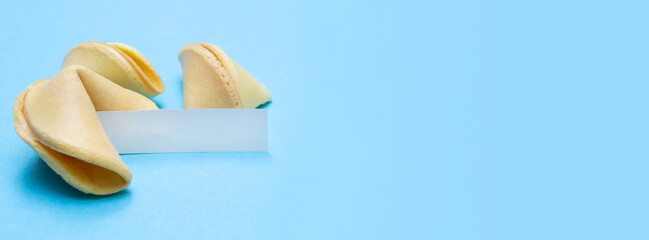 Banner with fortune cookies on a blue background and place for text. Mockup. Blank paper for...