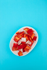 fresh red sweet pepper with onion on white dish