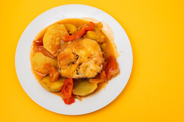 typical portuguese fish stew on white plate
