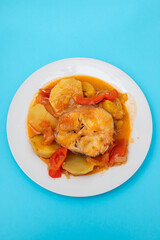 typical portuguese fish stew on white plate